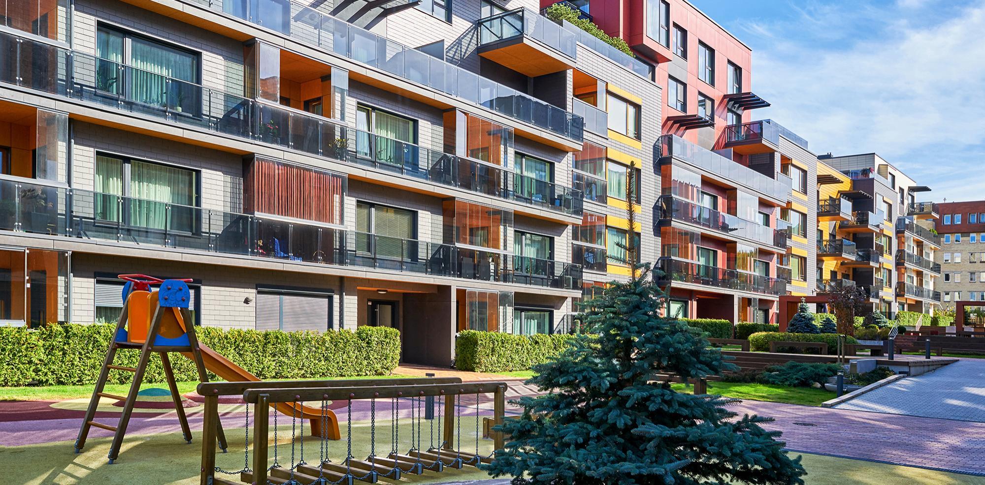 Modern apartment buildings with playground equipment in the city