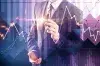 Businessman in front of a stock chart and a company chart.