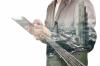 Businessman using a tablet with in the background a view of the city.