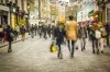 A blurred image of people walking down a street.