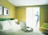 Suitcase lying on a bed in a hotel room.